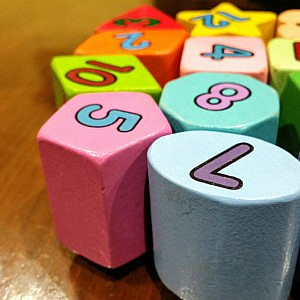 multi-coloured wooden toy building blocks on a wooden surface