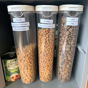 three lablled cereal containers used to store pet food