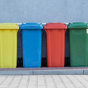 Row of organised coloured recycling bins