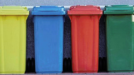 Row of organised coloured recycling bins