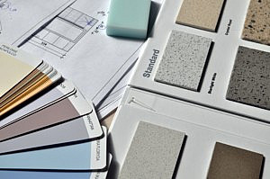paint swatches and renovation plans laid out on a table in an organised home renovation