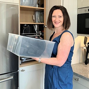 APDO member Diana Spellman of Serenely Sorted organising a kitchen cupboard
