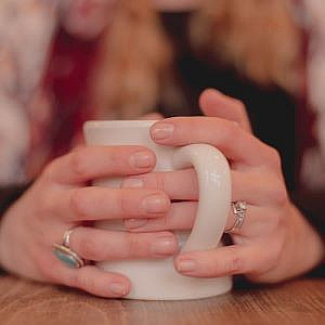 Hands around a mug