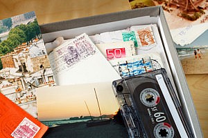 memory box filled with letters photos and cassette tape